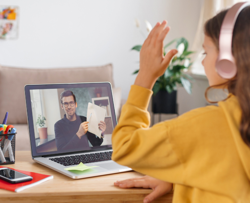 Digital learning: a school girl in front of a laptop learning from home, watching an online course