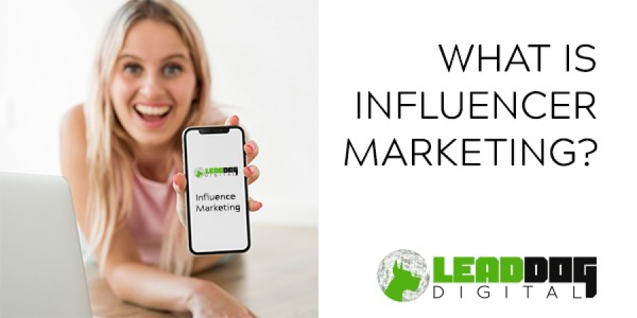 A girl with blue hair holding the phone with “influence marketing” written on the screen. The text “What is influencer marketing?” and the Lead Dog Digital logo are on the other half of the photo.