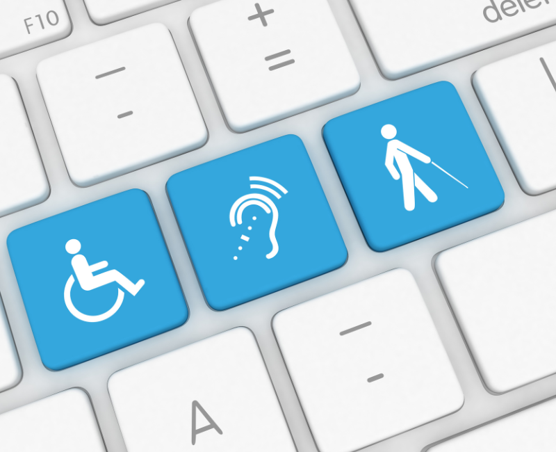 Three blue accessibility icons on a white computer keyboard